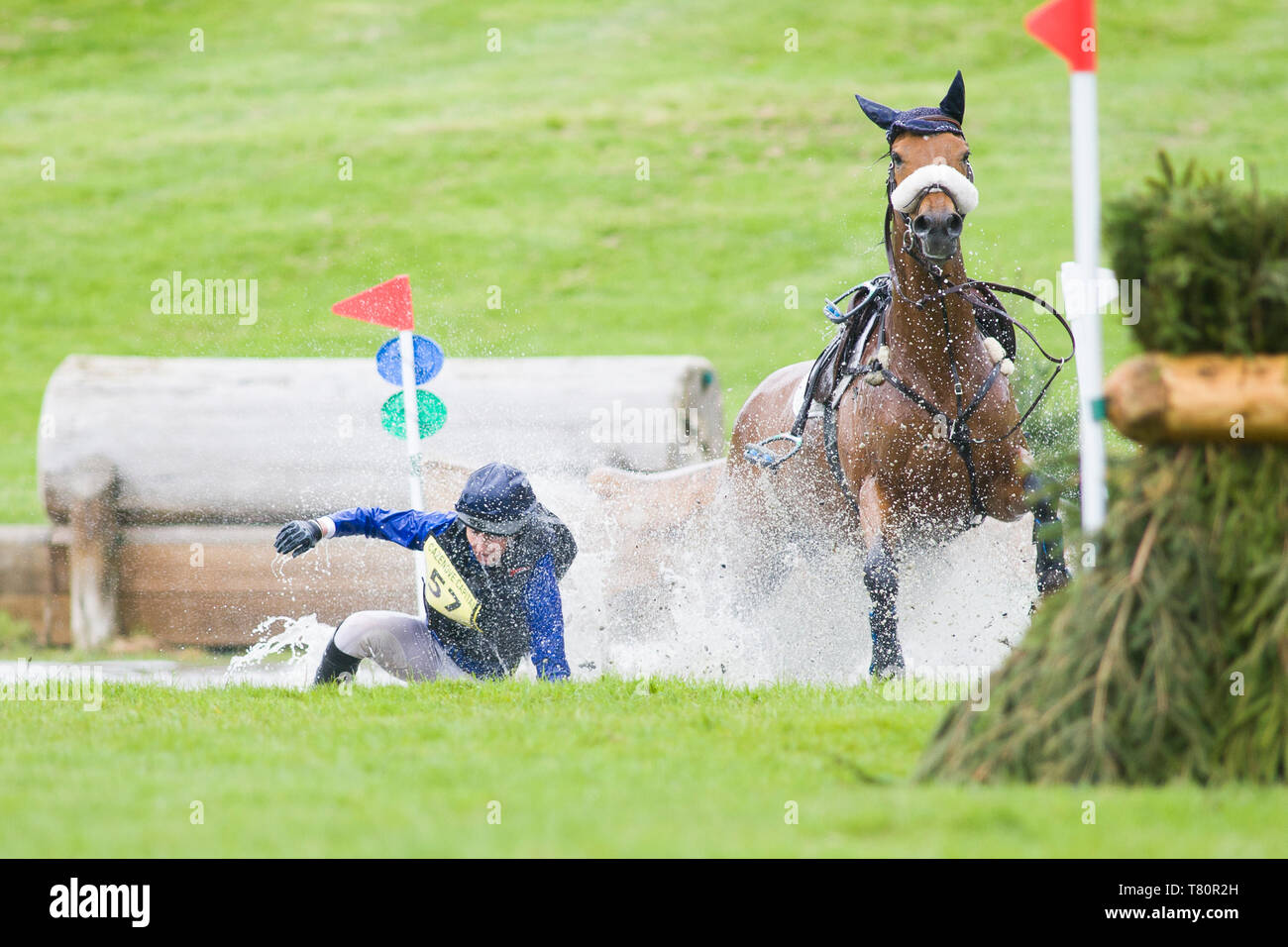 Kelso, Scottish Borders, UK. 10th May 2019. Rider 57 falls of her horse in the Cross Country in class CCI-S3* XC at the main water section on day 2 of the Floors Castle Horse Trials hosted in the grounds of Floors Castle, Kelso, Scottish Borders. Credit: Scottish Borders Media/Alamy Live News Stock Photo