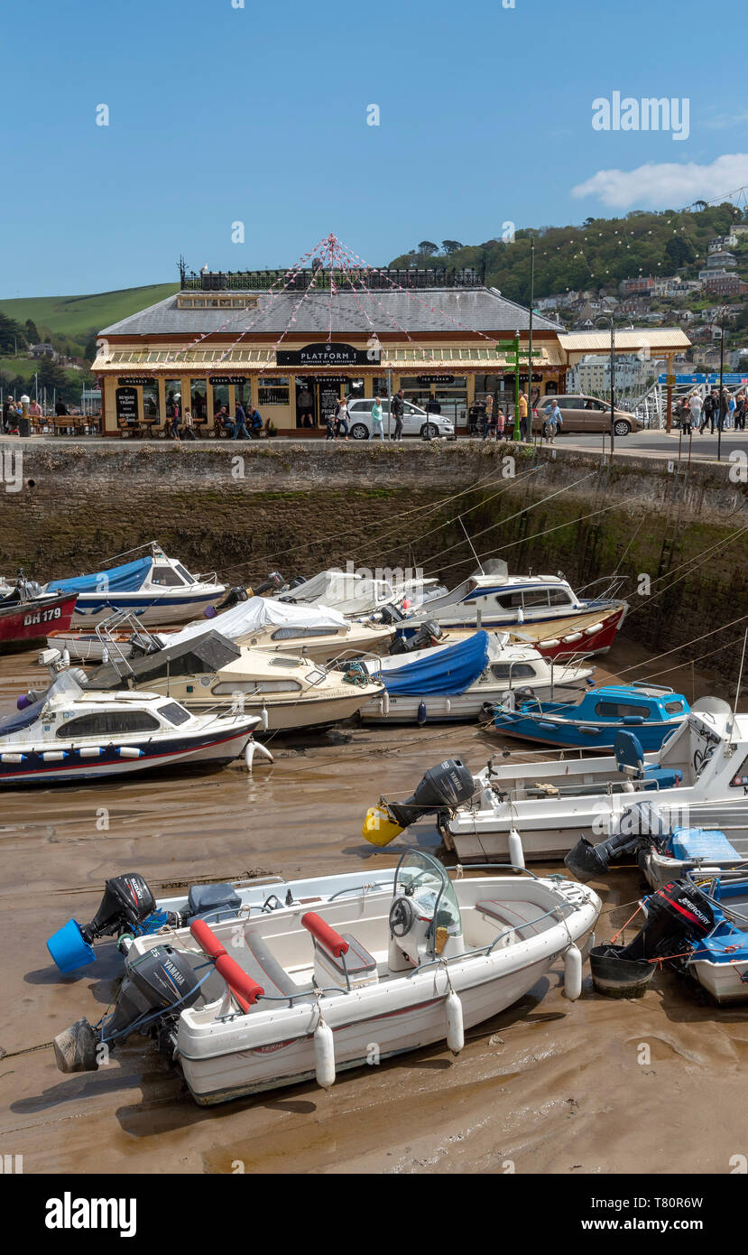 Dartmouth, South Devon, England, UK. May 2019. The old railway station now a cafe bar and old harbour at low tide Stock Photo