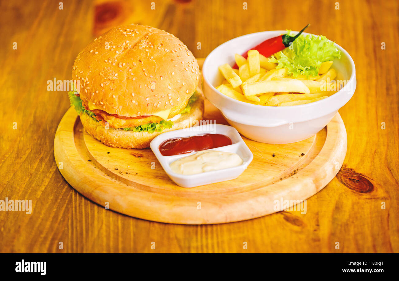 Burger menu. High calorie snack. Hamburger and french fries and tomato