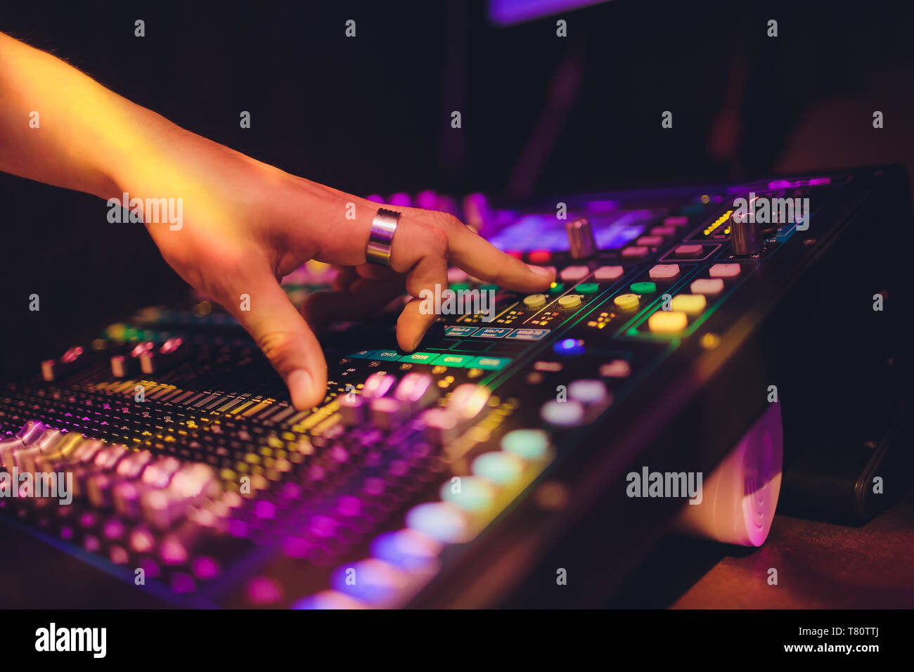 DJ turntable console mixer controlling with two hand in concert