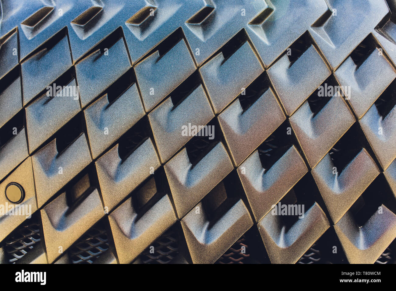 Grid of car with sunflare. Radiator grille. Metal closeup texture
