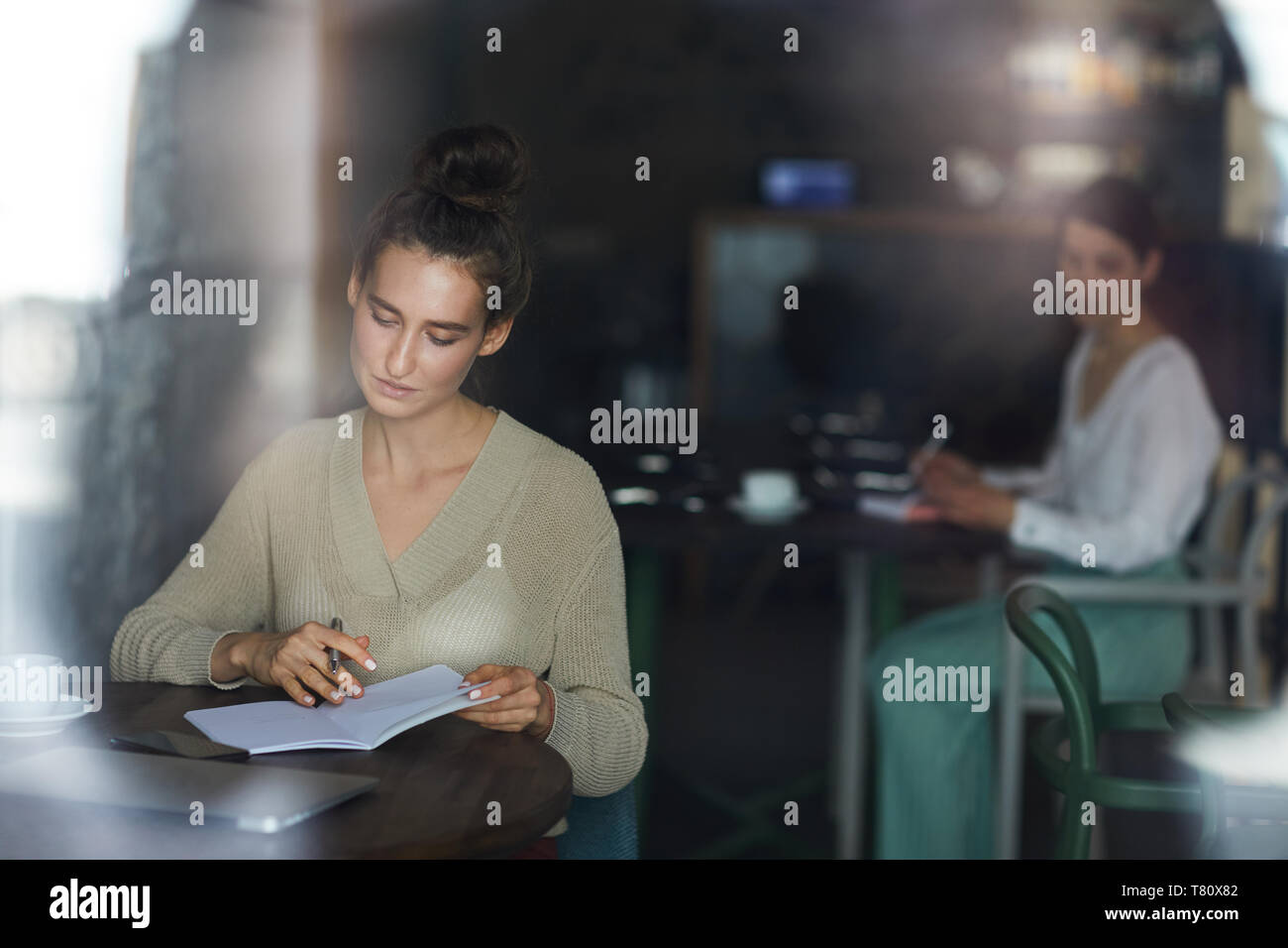 Reading notes in cafe Stock Photo