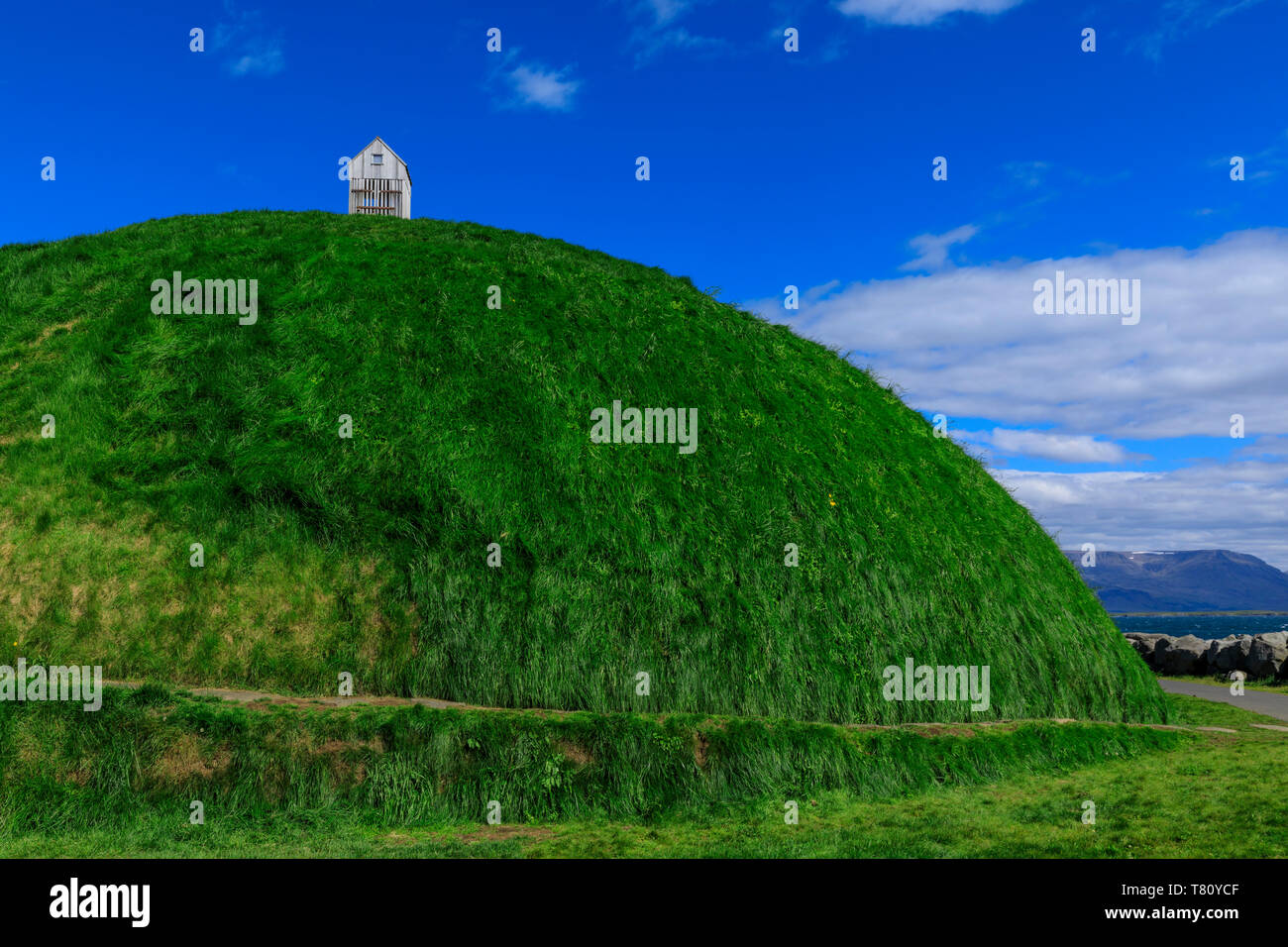 Thufa, green mound, blue sky, little house or fish drying shed in summer, Mount Esja, Old Harbour, Reykjavik, Iceland, Polar Regions Stock Photo