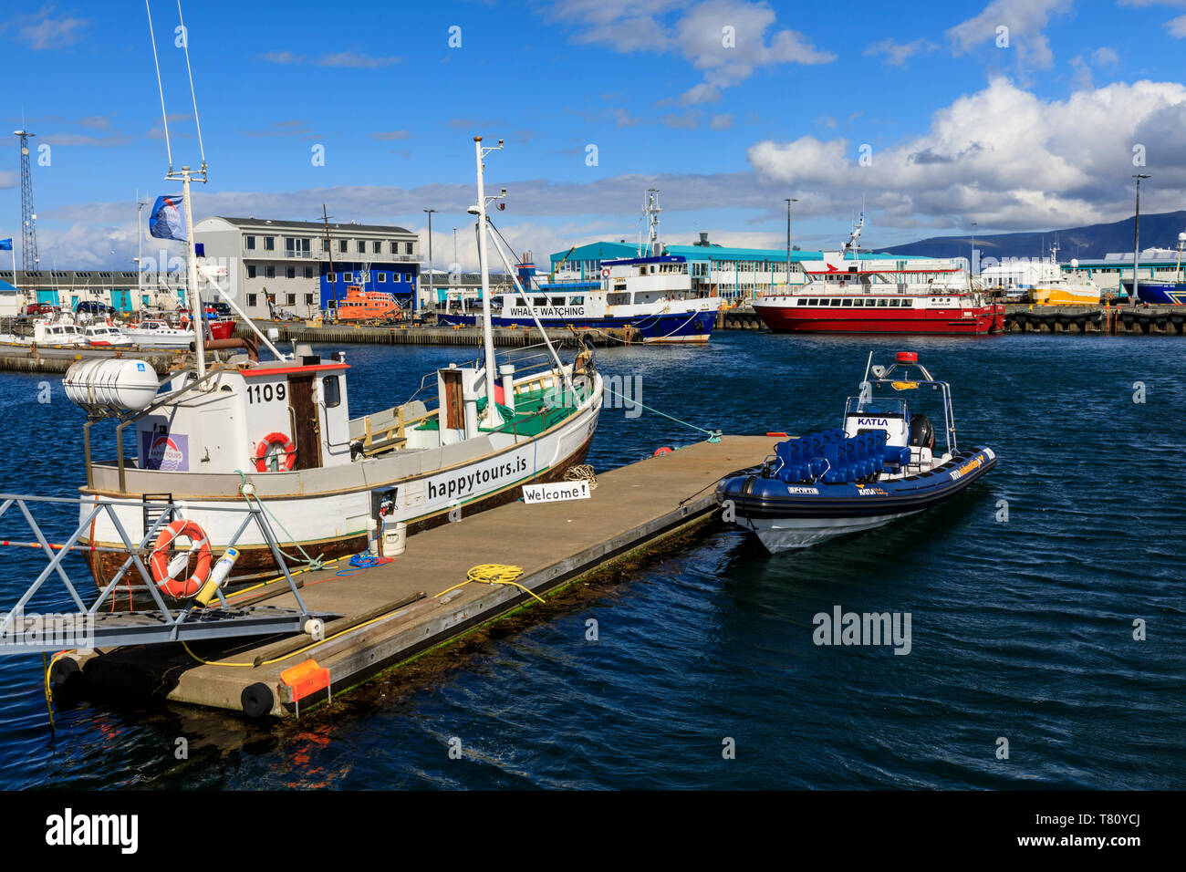 Colourful tour boats in Reykjavik Old Harbour, welcome sign, blue sea ...