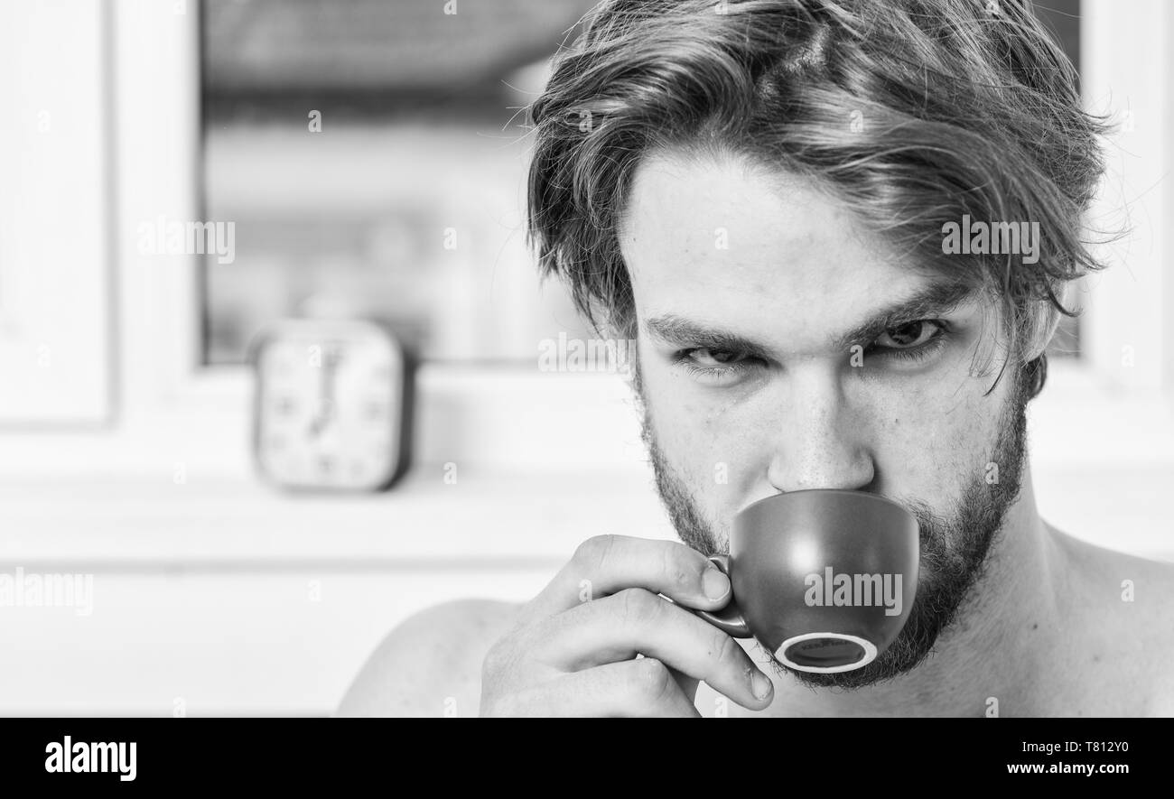 Man bearded handsome macho hold cup of coffee. Guy attractive