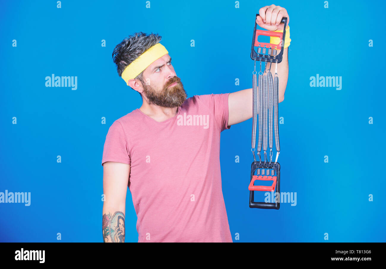 Athlete sport instructor. Athlete workout with expander. Sportsman ...