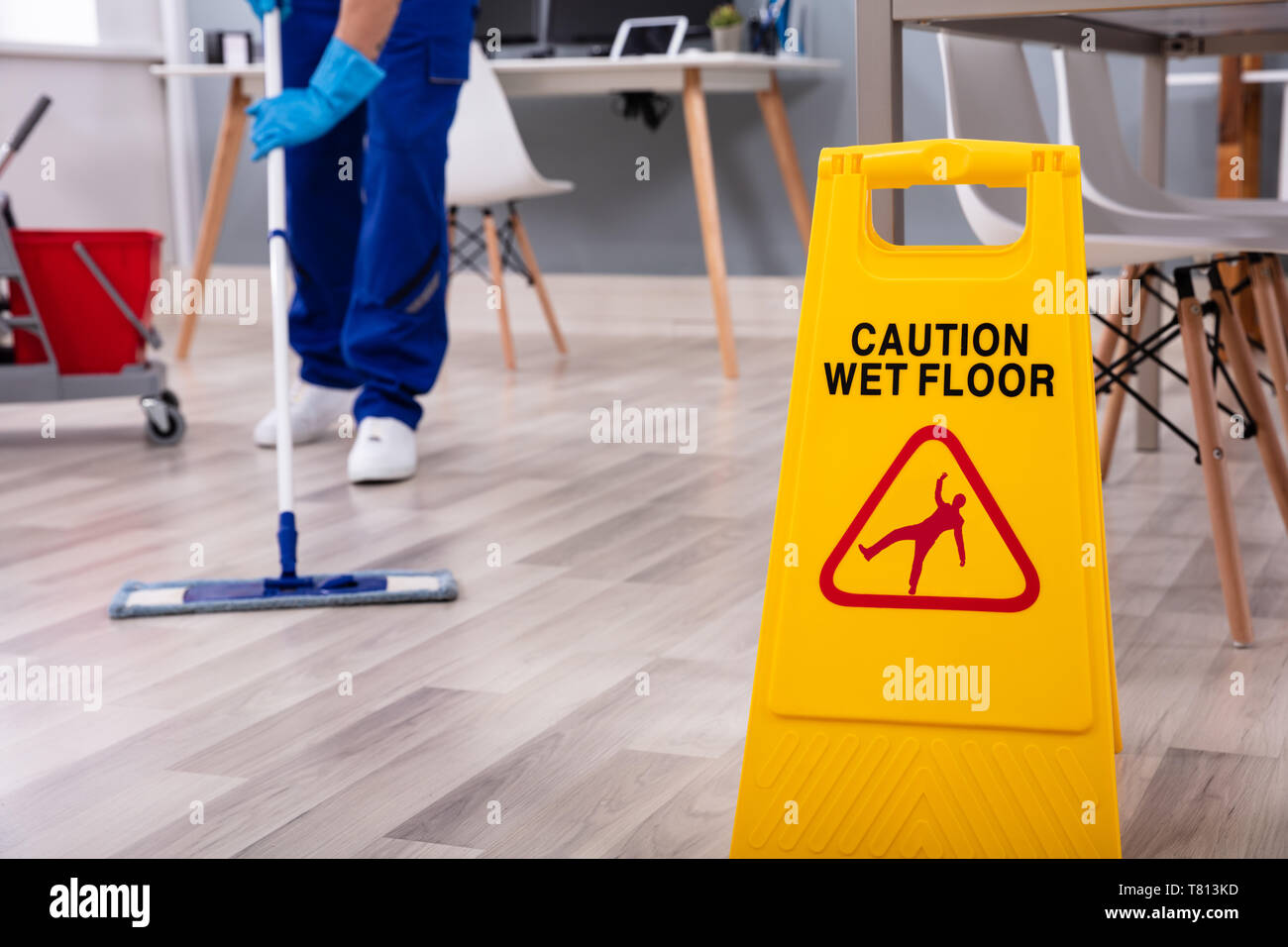 Male janitor with mop cleaning modern office floor Stock Photo Alamy