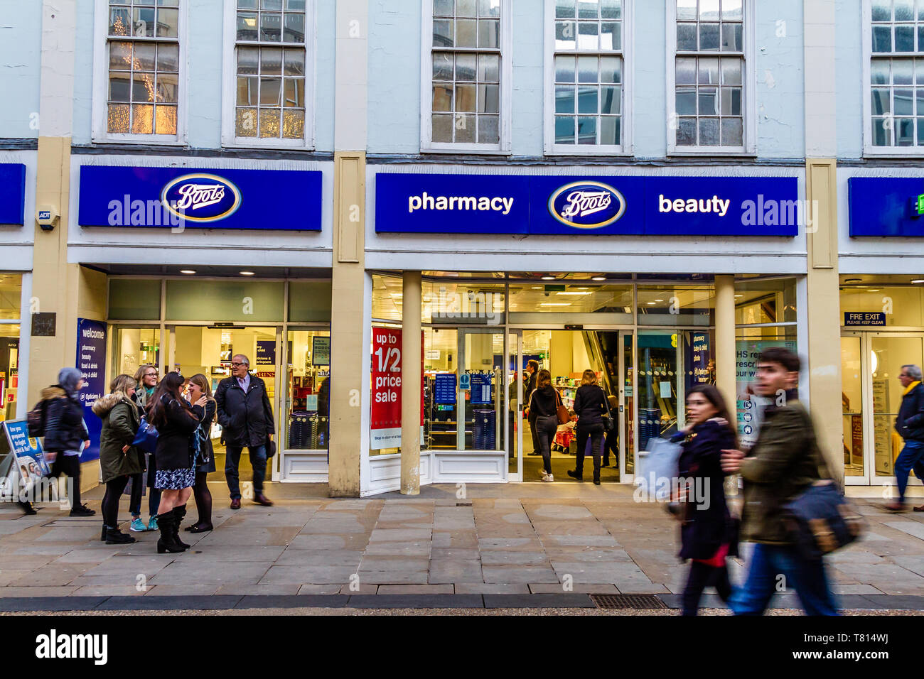 People walking past the front of Boots pharmacy or chemist in Oxford, UK. December 2018. Stock Photo