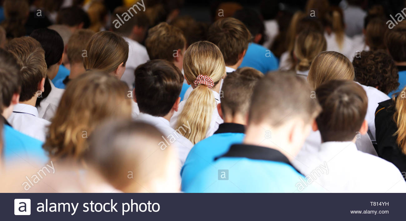Girl With Blonde Hair Patterned Hair Tie Hair Sitting At A High