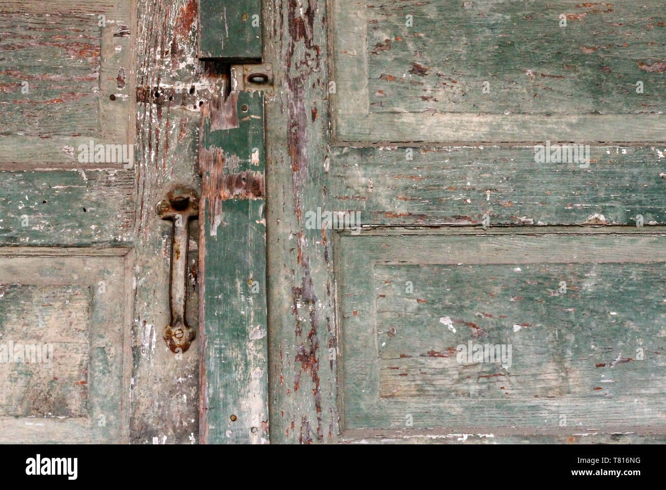 Old door handles and faded paint are an interesting architectural