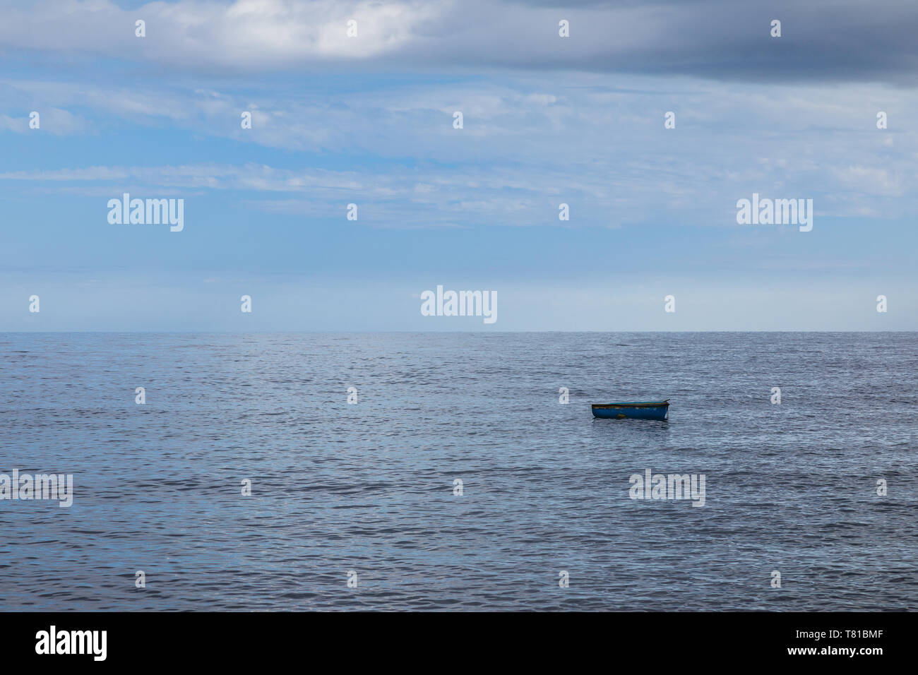 Lonely fishing boat on the calm surface of the ocean, Tenerife, Canary Island, Spain Stock Photo