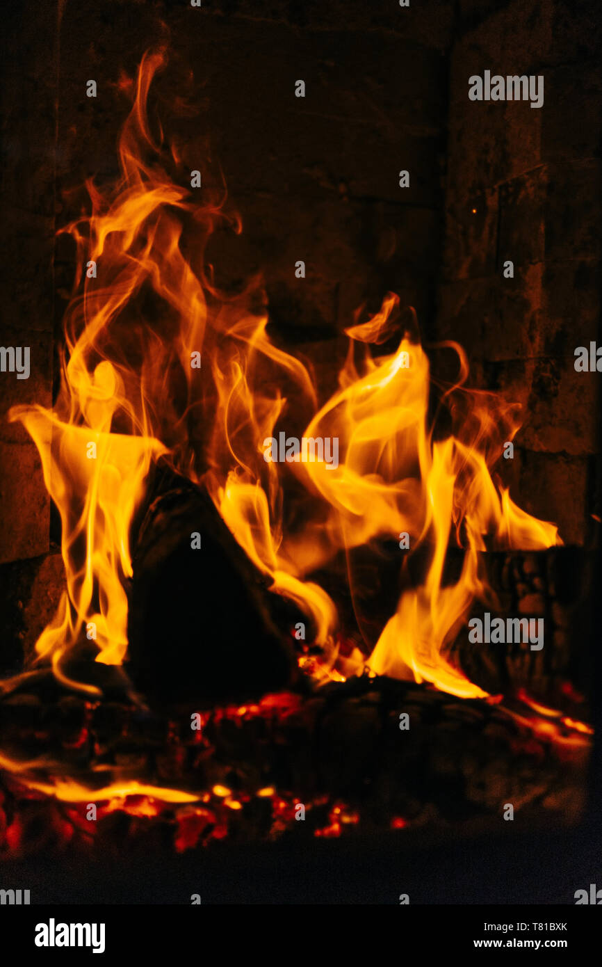 Close-up of fireplace with burning logs of wood. Stock Photo