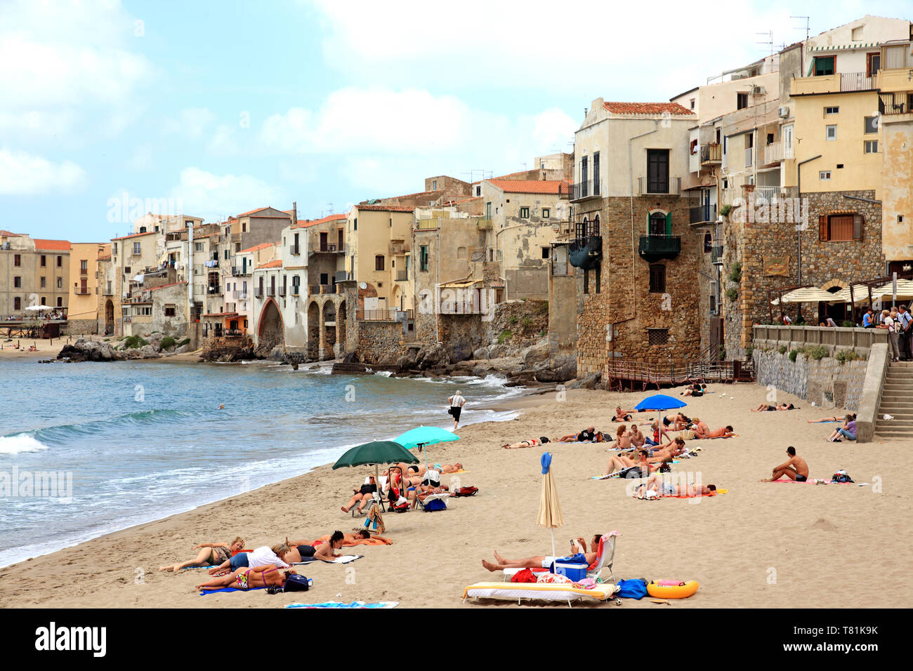 People enjoying the beach in Cefalu in Sicily Italy Stock Photo