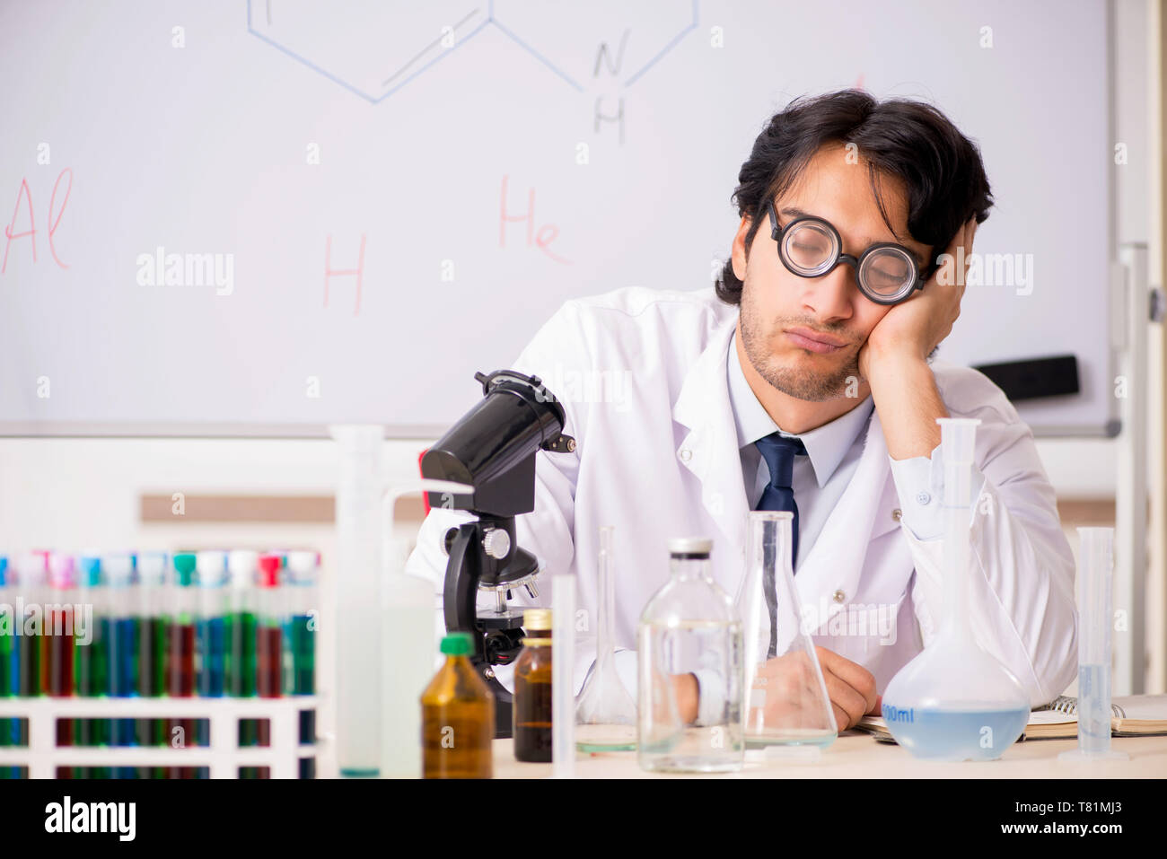 Young funny chemist in front of white board Stock Photo