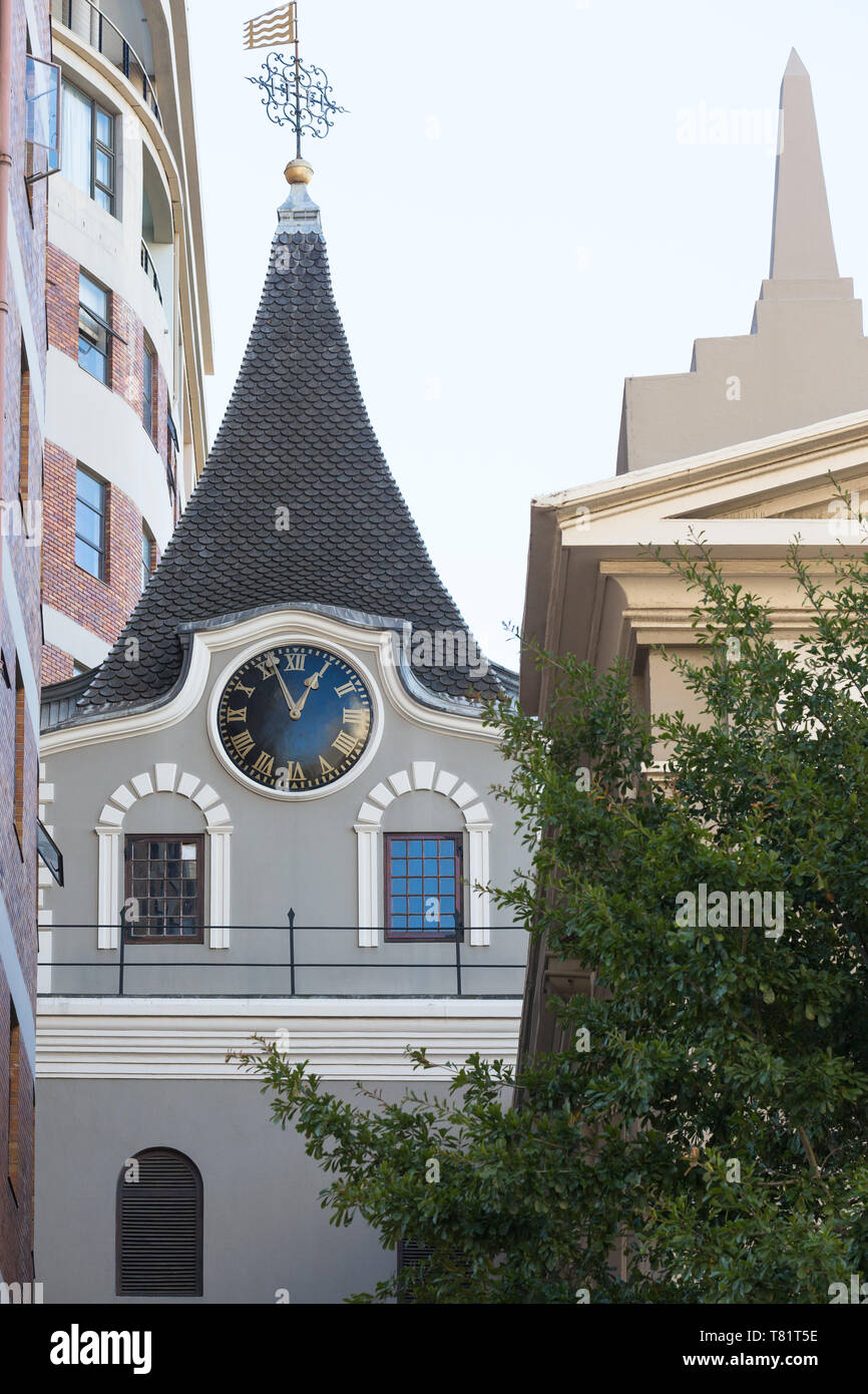 Church steeple and clock of an old historical era sandwiched between
