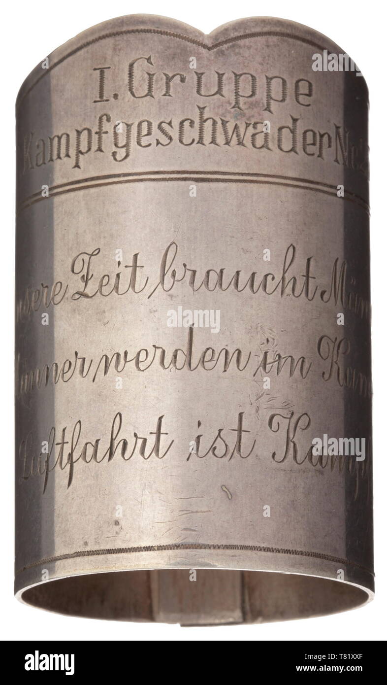 A flag- or battalion ring of 'I. Gruppe - Kampfgeschwader Nr. 257'. Silver ring with corresponding engraving and below 'Unsere Zeit braucht Männer. Männer werden im Kampf, Luftfahrt ist Kampf' (Our times require men. Men are formed in struggle, aviation is struggle). Triple- riveted. Total height 65 mm. Fineness mark '800'. Weight 73 g. KG 257 (Fighter Wing 257) was established in April 1937 and renamed KG 26 in May 1939. historic, historical, Air Force, branch of service, branches of service, armed service, armed services, military, militaria, air forces, object, objects, , Editorial-Use-Only Stock Photo