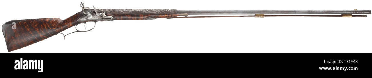 A flintlock shotgun, French/Flemish, beginning of the 18th century. Smooth bore barrel in 17.5 mm calibre, the rear with lavishly chiselled decorations depicting antique-like scenes. The flintlock not part of the original, engraved lockplate. Finely grained half stock made from thuja wood with iron furniture, the side plate replaced. Wooden ramrod with horn tip. Length 157 cm. historic, historical, civil long guns, gun, weapons, arms, weapon, arm, 18th century, Additional-Rights-Clearance-Info-Not-Available Stock Photo