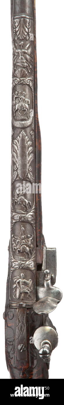 A flintlock shotgun, French/Flemish, beginning of the 18th century. Smooth bore barrel in 17.5 mm calibre, the rear with lavishly chiselled decorations depicting antique-like scenes. The flintlock not part of the original, engraved lockplate. Finely grained half stock made from thuja wood with iron furniture, the side plate replaced. Wooden ramrod with horn tip. Length 157 cm. historic, historical, civil long guns, gun, weapons, arms, weapon, arm, 18th century, Additional-Rights-Clearance-Info-Not-Available Stock Photo