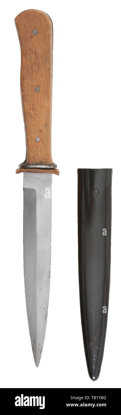 A combat fighting knife. Polished blade without manufacturer's trademark. Steel hilt with wood grip plates retained by three rivets. Black lacquered steel scabbard with belt/boot clip. Length 27 cm. USA-lot historic, historical, army, armies, armed forces, military, militaria, 20th century, Editorial-Use-Only Stock Photo