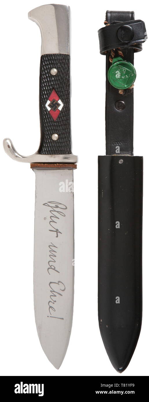 A Hitler Youth knife with motto etching and metal quality control tag. Maker Puma, Solingen. The blade with etched motto and manufacturer's trademark. Plated hilt, black plastic grip plates, enamelled HJ emblem with green-coloured metal factory control tag. Black lacquered steel scabbard with riveted black leather hanger. Length 25 cm. USA-lot historic, historical, 20th century, 1930s, League of German Girls, Band of German Maidens, youth organization, youth organizations, NS, National Socialism, Nazism, Third Reich, German Reich, Germany, National Socialist, Nazi, Nazi per, Editorial-Use-Only Stock Photo
