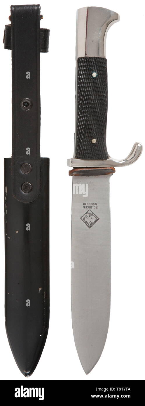A Hitler Youth knife with motto etching and metal quality control tag.  Maker Puma, Solingen. The blade with etched motto and manufacturer's  trademark. Plated hilt, black plastic grip plates, enamelled HJ emblem