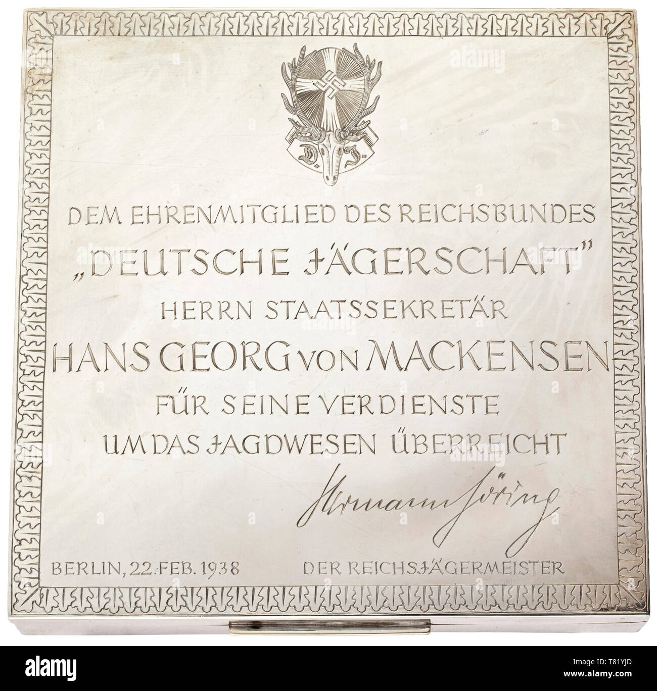 Hermann Göring - Hans Georg von Mackensen. A silver cigaret- te casket presented by Göring as Reich Master Huntsman to Mackensen for his services to hunting, the cover with an engraved dedication surmounting the emblem of the Deutsche Jägerschaft (German Hunting Association) 'Dem Ehrenmitglied des Reichsbundes der Deutschen Jägerschaft - Herrn Staatssekretär Hans Georg von Mackensen - für seine Verdienste um das Jagdwesen überreicht - Hermann Göring - Berlin 22. Februar 1938 - Der Reichsjägermeister' (Presented to Honorary Member of the Reich League of the German Hunting As, Editorial-Use-Only Stock Photo