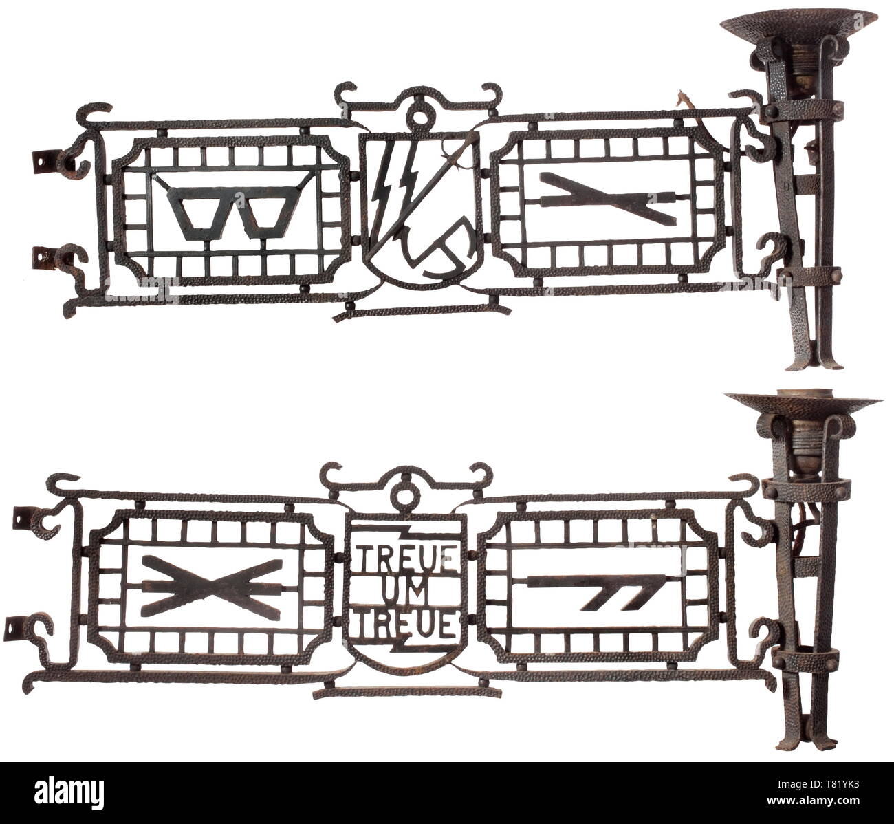 A ceiling light with runes and motto, six-armed, cast iron with hand-forged elements, the interstices with runes and banderoles 'Treue um Treue' and 'Meine Ehre heißt Treue'. The individual pieces elaborately decorated, and held together by means of screws and pins. Six post-war 110-volt light bulbs enclosed. Not checked for functionality, electrical installation must be renewed by a professional. Arm dimensions ca. 55 x 24 cm. The consignor states the object comes from a graduate of the Bad Tölz Junker school. Outstanding craftmanship, age marks, not mounted. Very rare. hi, Editorial-Use-Only Stock Photo