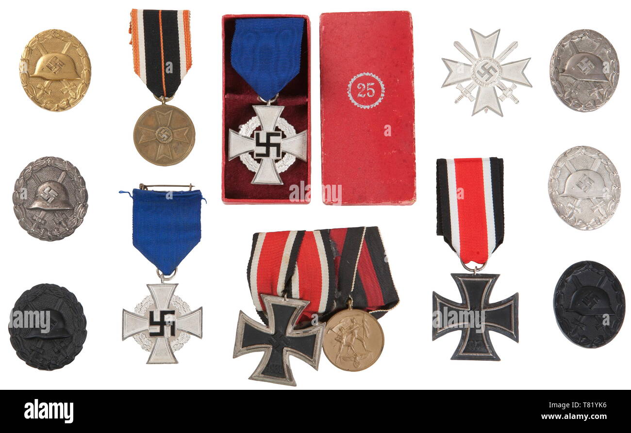 A collection of awards. 1938 25 years Faithful Service Cross in case, 1938 25 years Faithful Service Cross in Silver, 1st Type Black and Silver Wound Badge, 2nd Type Black, Gold and two Silver Wound Badge's, 2 Place Medal Bar ( EK II & Oct 1938 occupation), 1939 War Merit Cross with Swords 1st Class, 1939 Iron Cross 2nd Class, and 1939 War Merit Medal. USA-lot historic, historical, awards, award, German Reich, Third Reich, Nazi era, National Socialism, object, objects, stills, medal, decoration, medals, decorations, clipping, cut out, cut-out, cut-outs, honor, honour, Natio, Editorial-Use-Only Stock Photo