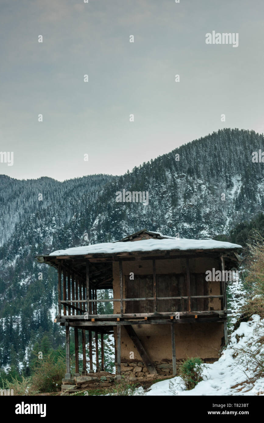 Snow covered wooden house in mountains - Majestic winter landscape in ...