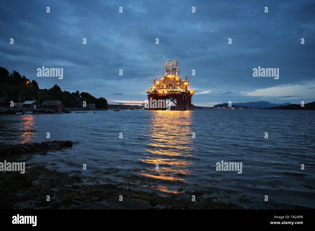 Offshore drilling rig under construction in a fiord in Norway. Oil industry structure. Stock Photo