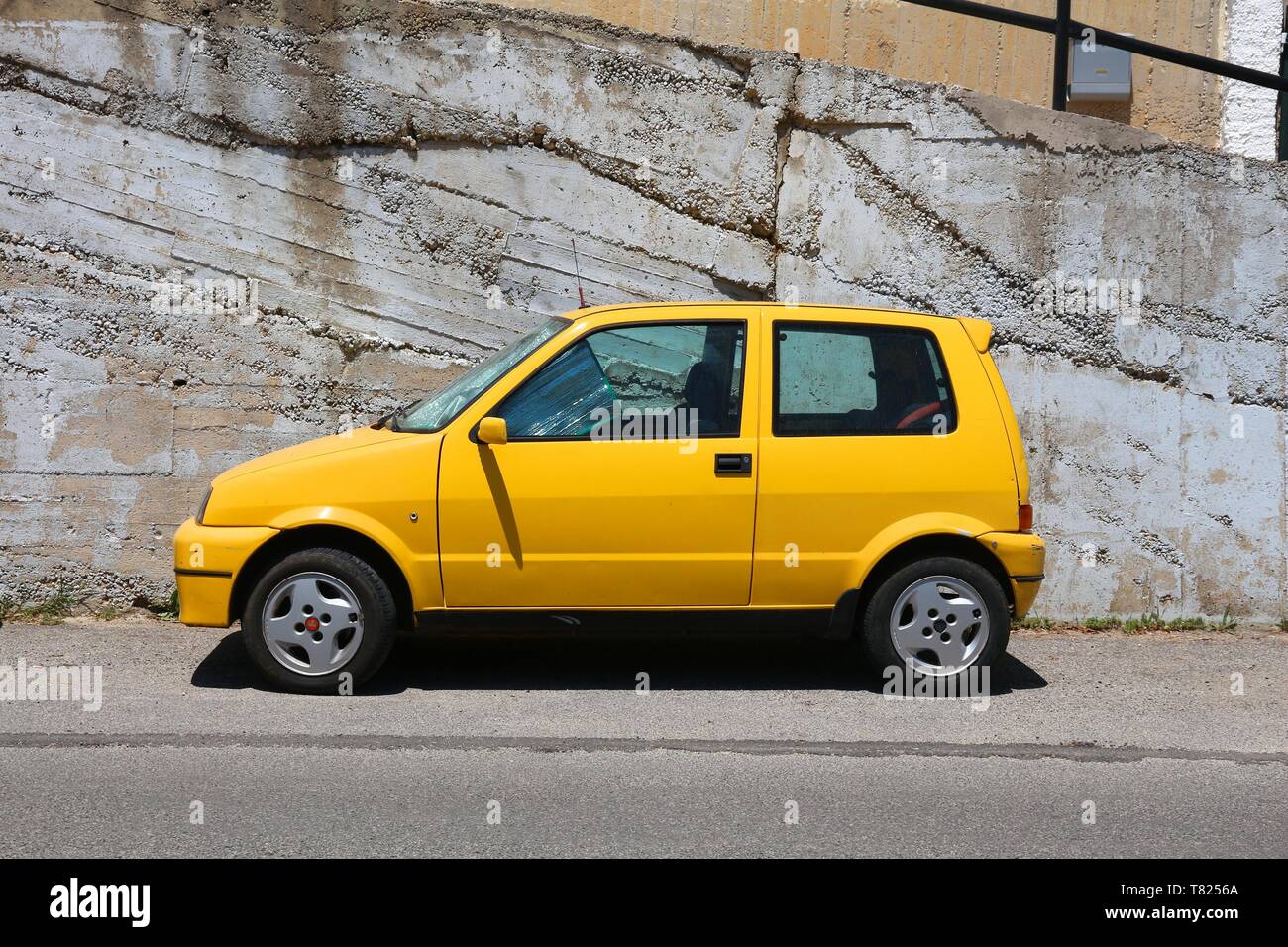 CORFU, GREECE - JUNE 2, 2016: Fiat Cinquecento yellow hatchback car parked in Corfu Island, Greece. With 566 registered vehicles per 1000 inhabitants  Stock Photo