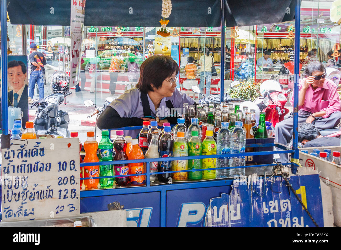 Bangkok, Thailand - April 21st 2011: Woman behind her mobile drinks stall in Chinatown. People often buy drinks as it is so hot. Stock Photo