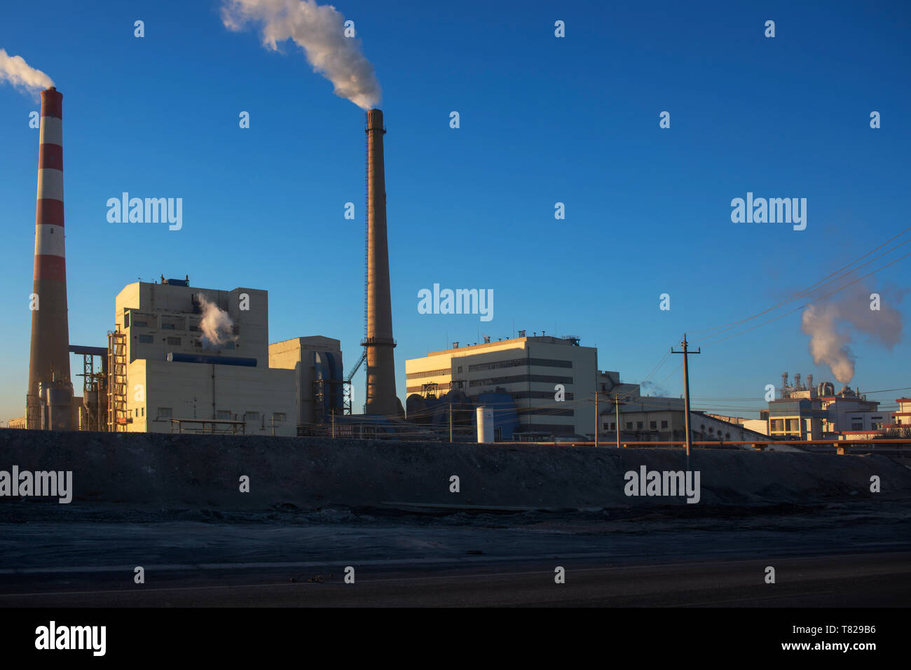 The panorama of the chemical plant is at sunrise. Stock Photo