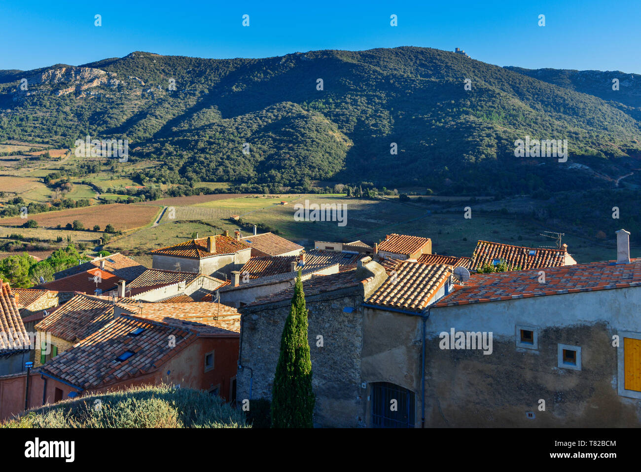 The village of Cucugnan in the French Pyrenees Orientales. This view looks towards the ruins of the medieval Chateau Queribus. Stock Photo