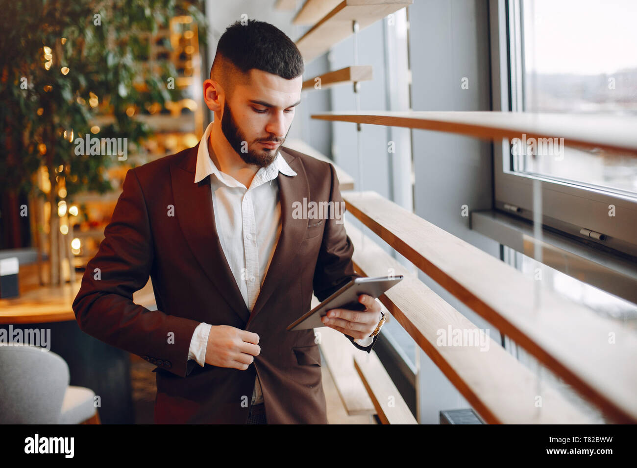 Handsome man in a black suit. Businessman working in a office Stock Photo -  Alamy