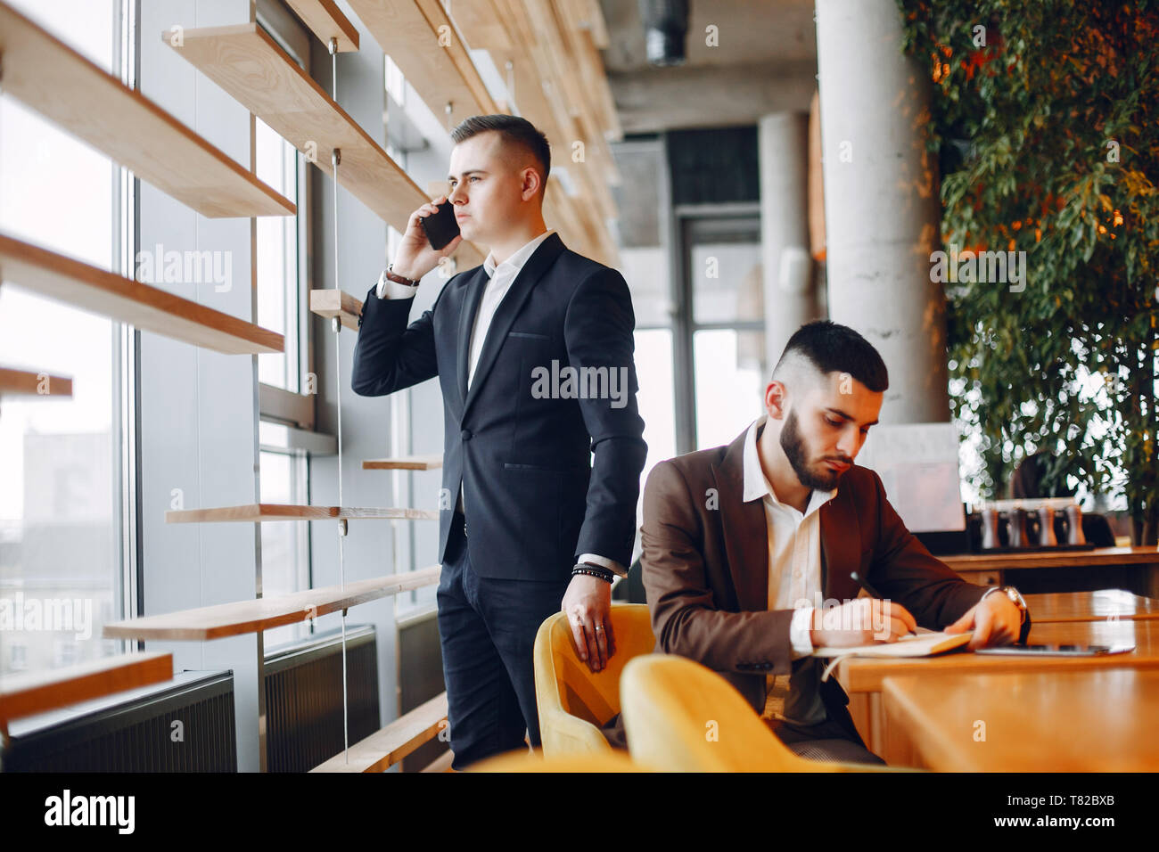 Two men one suit hi-res stock photography and images - Alamy