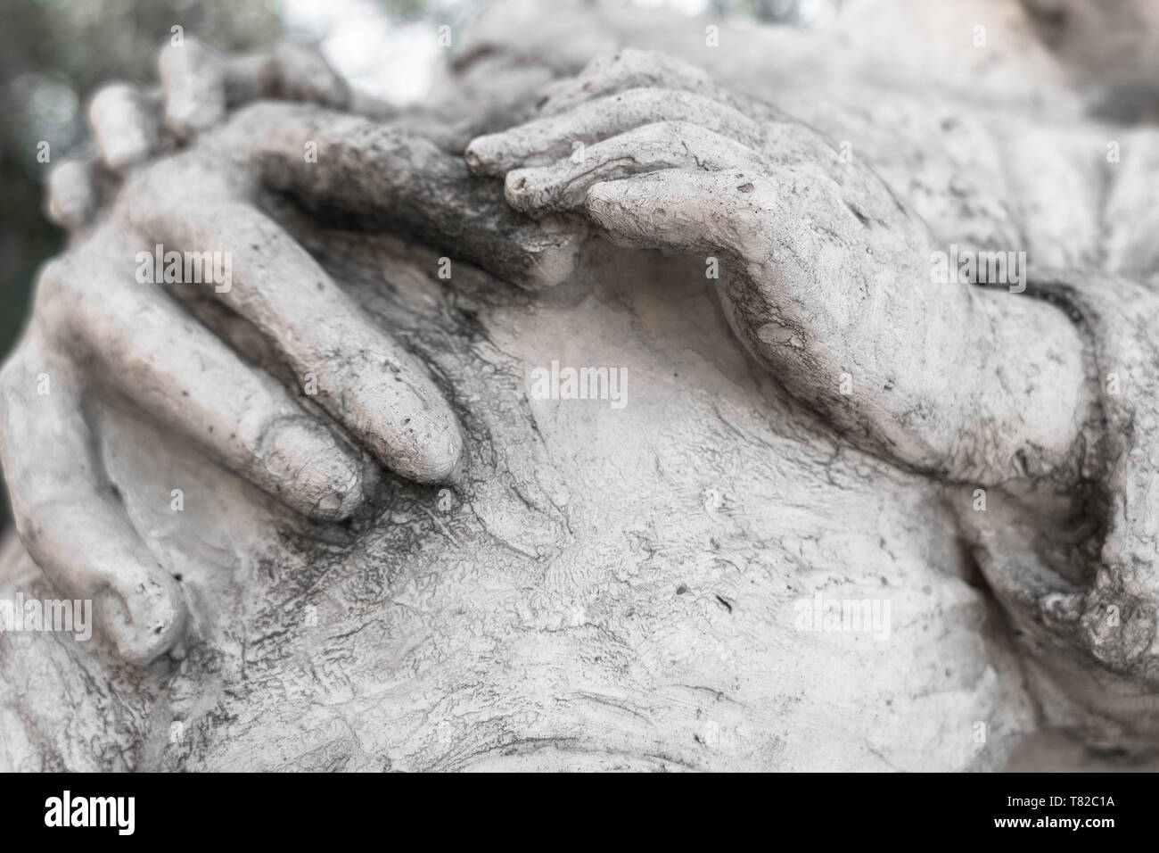 Detail of a marble statue with hands of child and woman together. Stock Photo
