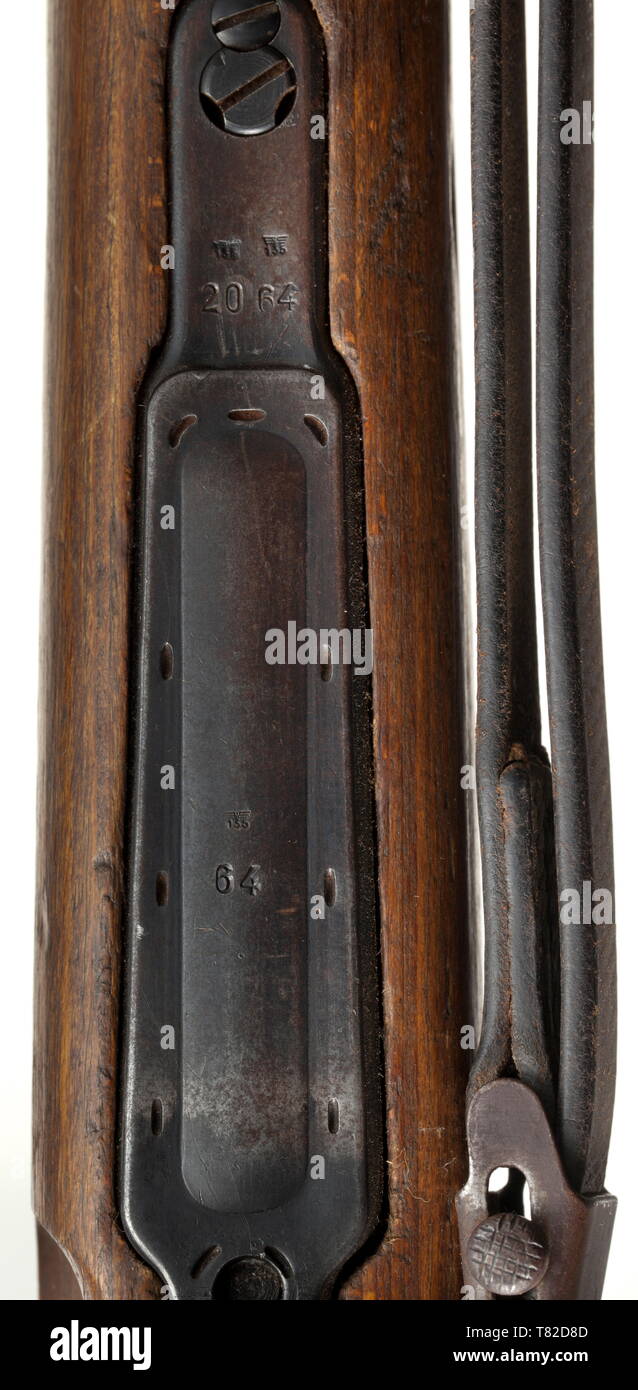 A scope rifle 98 k, Mauser, with high top-hinged mount and scope Dialytan, cal. 8 x 57, no. 42064d. Matching numbers. Mirror-like bore. Code on receiver head covered by front mount base, but various acceptance marks eagle/'135'. According to serial number manufactured after 1944 at Mauser-Werke AG, Oberndorf. Sheet steel-stamped magazine plate. Original finish, partially thin and somewhat spotted. Dark laminated stock without external number, not taken apart. Complete with strapping, pitted cleaning rod and front sight guard. Mounted with high to, Additional-Rights-Clearance-Info-Not-Available Stock Photo