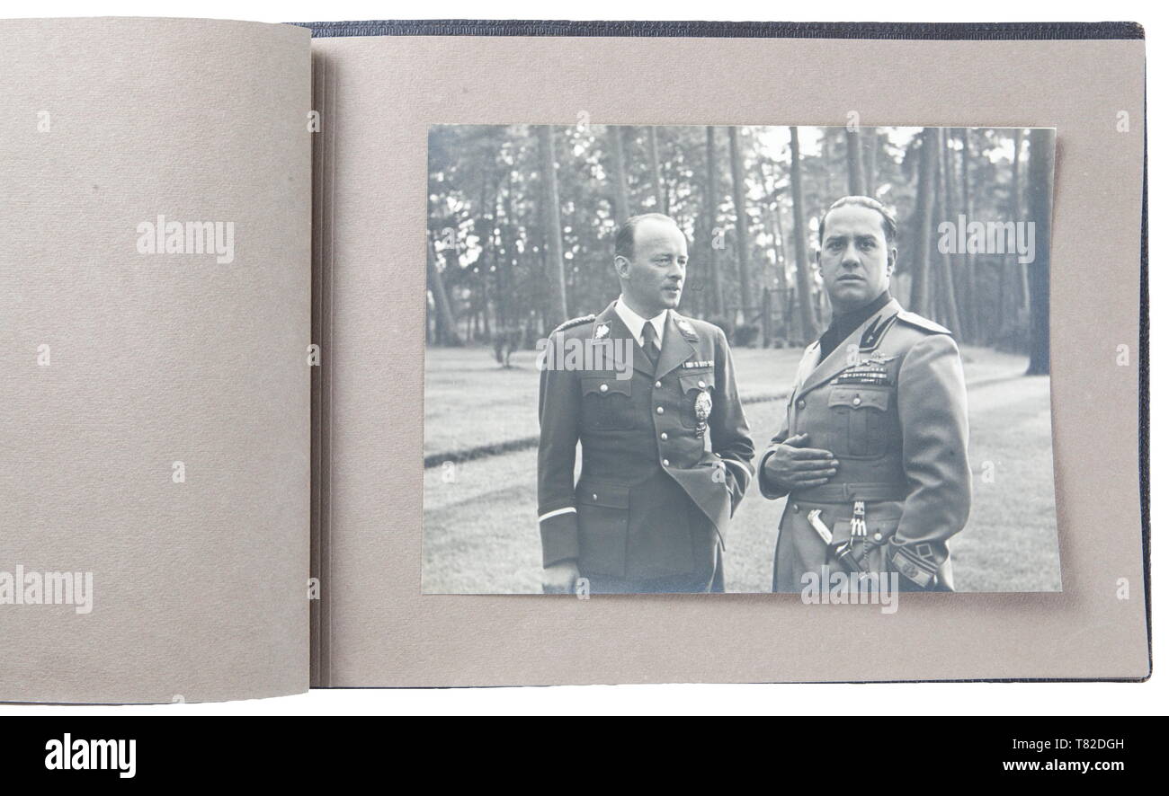 Hermann Göring - A photo album of Mussolini's official visit to Carinhall Large format photo album (34 x 24 cm) with brown leather cover with gold-embossed 'MUSSOLINI BEI GOERING IN KARINHALL', '28 SEPTEMBER 1937' and 'BILDBERICHT VON CARLO CARLETTI'. Album consists of eighteen 17 x 23 cm black and white photos. Photos are of a casual/informal style and feature Hermann Göring, Emma Göring, Mussolini, Count Ciano, Achille Starace, Luftwaffe Generals Milch, Stumpf, and Bodenschatz, Paul Schmidt, SS General Dietrich, and more. From the possession of a US officer of the 101st A, Editorial-Use-Only Stock Photo