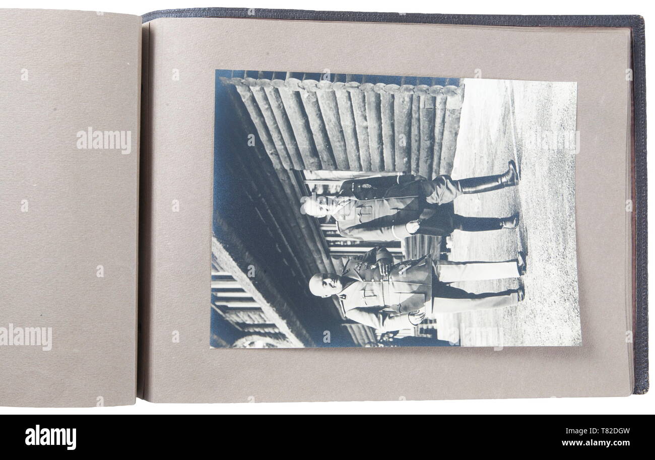 Hermann Göring - A photo album of Mussolini's official visit to Carinhall Large format photo album (34 x 24 cm) with brown leather cover with gold-embossed "MUSSOLINI BEI GOERING IN KARINHALL", "28 SEPTEMBER 1937" and "BILDBERICHT VON CARLO CARLETTI". Album consists of eighteen 17 x 23 cm black and white photos. Photos are of a casual/informal style and feature Hermann Göring, Emma Göring, Mussolini, Count Ciano, Achille Starace, Luftwaffe Generals Milch, Stumpf, and Bodenschatz, Paul Schmidt, SS General Dietrich, and more. From the possession of a US officer of the 101st A, Editorial-Use-Only Stock Photo