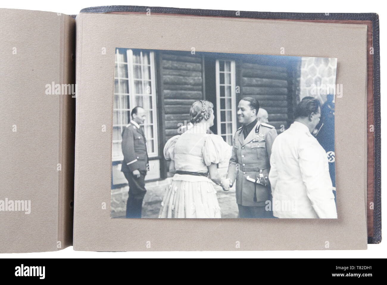 Hermann Göring - A photo album of Mussolini's official visit to Carinhall Large format photo album (34 x 24 cm) with brown leather cover with gold-embossed 'MUSSOLINI BEI GOERING IN KARINHALL', '28 SEPTEMBER 1937' and 'BILDBERICHT VON CARLO CARLETTI'. Album consists of eighteen 17 x 23 cm black and white photos. Photos are of a casual/informal style and feature Hermann Göring, Emma Göring, Mussolini, Count Ciano, Achille Starace, Luftwaffe Generals Milch, Stumpf, and Bodenschatz, Paul Schmidt, SS General Dietrich, and more. From the possession of a US officer of the 101st A, Editorial-Use-Only Stock Photo