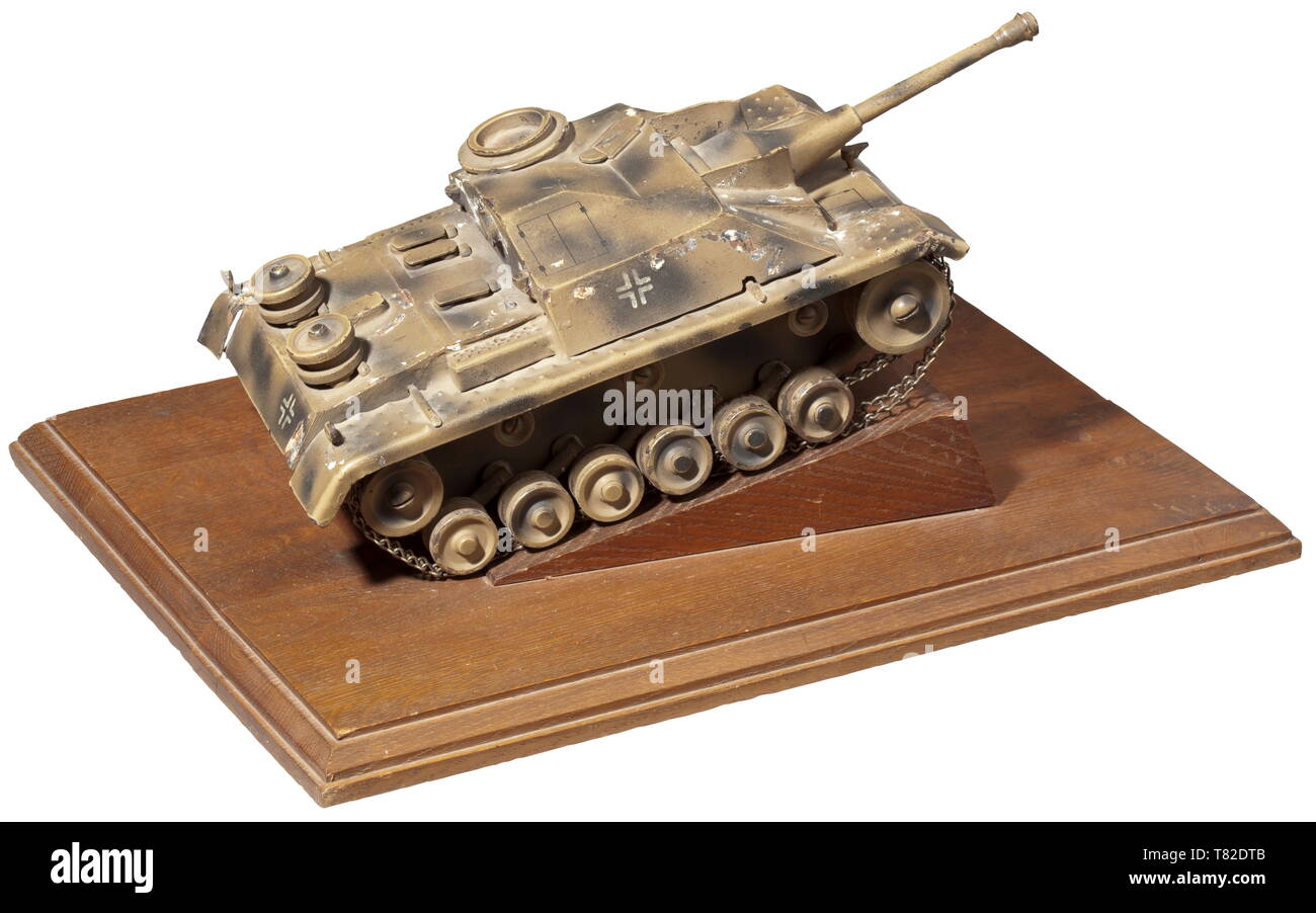 An assault gun III model - a present from the test group to Major Haarberg Very detailed metal model of the STUG III in version G in camouflage paint (flaws) on a wooden base (the model is detachable) with dedication (tr) 'To Major Haarberg with cordial greetings on 1 July 1944 - Berg 1.7.1944 - The Test Group'. A very decorative officer's present from the test group of the assault gun school Burg to the deputy commander. Dimensions with base 42 x 31 cm. historic, historical, 20th century, armoured corps, armored corps, tank force, tank forces, branch of service, branches o, Editorial-Use-Only Stock Photo