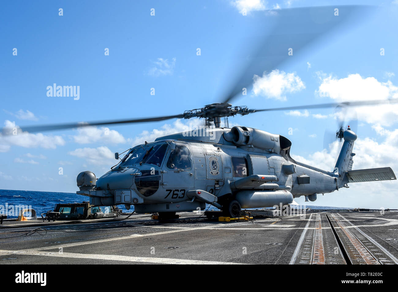 190410-N-UM706-0040 ATLANTIC OCEAN (April 10, 2019) An MH-60R Sea Hawk Helicopter, assigned to the “Grandmasters” of Helicopter Maritime Strike Squadron (HSM) 46, prepares to take off of the flight deck aboard the Arleigh Burke-class guided-missile destroyer USS Nitze (DDG 94). Nitze is underway as part of Abraham Lincoln Carrier Strike Group (ABECSG) deployment in support of maritime security cooperation efforts in the U.S. 5th, 6th and 7th Fleet areas of responsibility. With Abraham Lincoln as the flagship, deployed strike group assets include staffs, ships and aircraft of Carrier Strike Gro Stock Photo