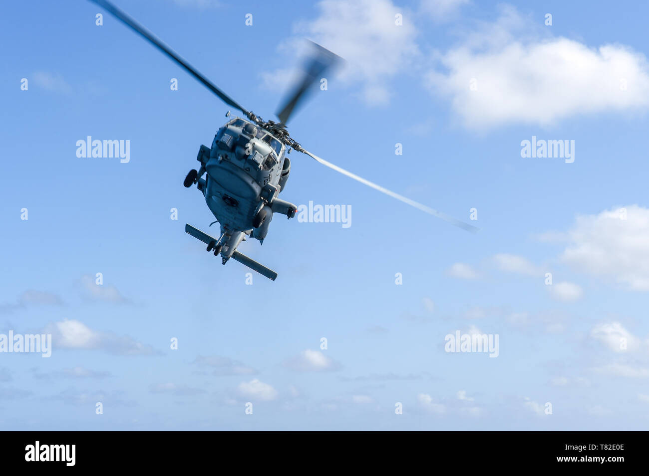 190410-N-UM706-0141 ATLANTIC OCEAN (April 10, 2019) An MH-60R Sea Hawk Helicopter assigned to the “Grandmasters” of Helicopter Maritime Strike Squadron (HSM) 46 conducts a fly-by of the Arleigh Burke-class guided-missile destroyer USS Nitze (DDG 94). Nitze is underway as part of Abraham Lincoln Carrier Strike Group (ABECSG) deployment in support of maritime security cooperation efforts in the U.S. 5th, 6th and 7th Fleet areas of responsibility. With Abraham Lincoln as the flagship, deployed strike group assets include staffs, ships and aircraft of Carrier Strike Group 12 (CSG 12), Destroyer Sq Stock Photo