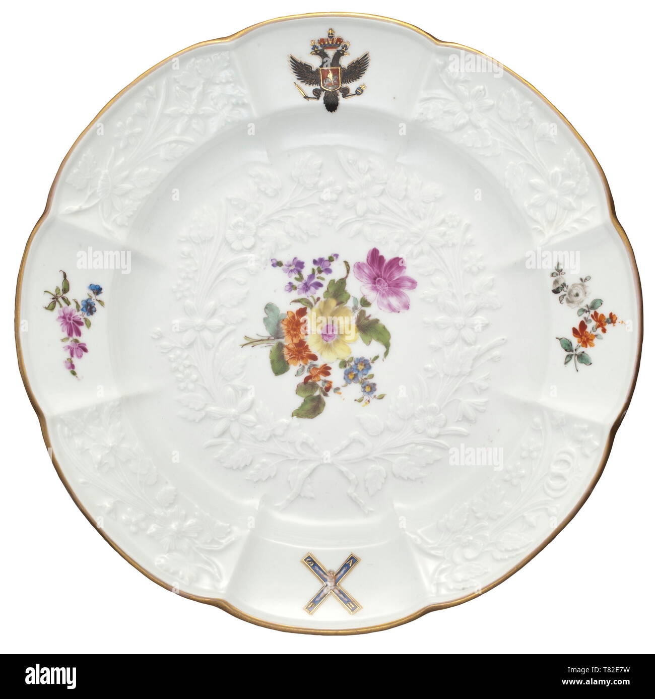 An important plate from the St. Andrew service, Meissen Porcelain Factory, circa 1774/75 Designed by J.F. Eberlein, 1744. White glazed porcelain, the border and centre with floral decoration (Gotzkowsky) in fine relief. In the centre a hand-painted bouquet, the border with a Russian double-headed eagle surmounted by a tsar's crown and the St. Andrew's Cross, gilt rim. Blue underglaze mark of crossed swords and red Hermitage inventory number on the bottom. Diameter 24.7 cm. Extremely good condition and quality. Rare. The plate is a piece from the , Additional-Rights-Clearance-Info-Not-Available Stock Photo