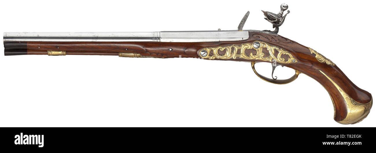 A flintlock pistol, Christoph Joseph Frey, Munich, circa 1730 Two-stage smooth bore barrel in 13 mm calibre, octagonal then round after a girdle. At the breech (replaced) brass inlays inscribed with 'FREY'. The flintlock chiselled with hunting themes and flowers, signed near the powder pan 'C. JOS. FREY IN MÜNCHEN'. Carved walnut stock (the forestock glued with replacements and a later horn nosepiece). Brass furniture with hunting themes in relief and openwork side plate, the pommel plate with antique bust, the escutcheon with engraved coat of ar, Additional-Rights-Clearance-Info-Not-Available Stock Photo