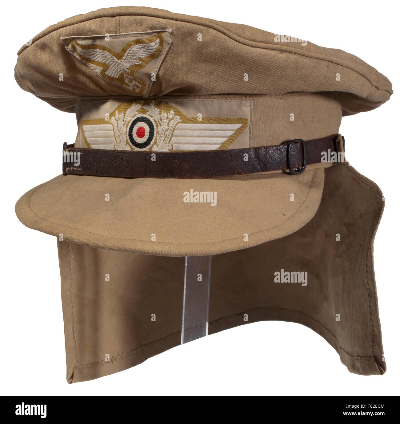 A visor cap for the tropical uniform The so-called "Hermann Maier Mütze".  Soft issue of sand-coloured cotton, metal ventilation eyelets and woven  insignia on a sand-coloured background, brown chin strap (damaged),  button-up