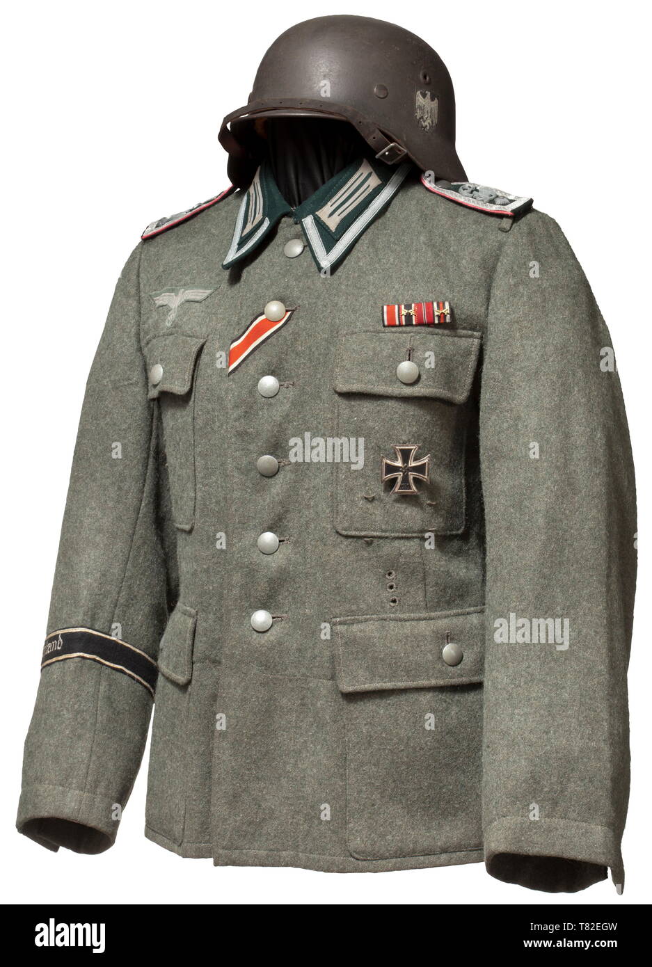 A field tunic M 43 for a Feldwebel in Panzer Regiment "Großdeutschland" Made of field-grey woollen cloth, dark green turn-down collar with stitched-on collar patches and NCO lace, machine-embroidered national eagle, the petrol blue silk inner liner with size- and depot stampings "161 - 165,39 100 59" and "T43". Looped shoulder boards with pink piping, applied rank stars and "GD" cipher in fine zinc (broken). Affixed to the uniform is the original sewn-on sleeveband "Großdeutschland", an Iron Cross 1st Class of 1939 (early issue), a field orders c, Additional-Rights-Clearance-Info-Not-Available Stock Photo