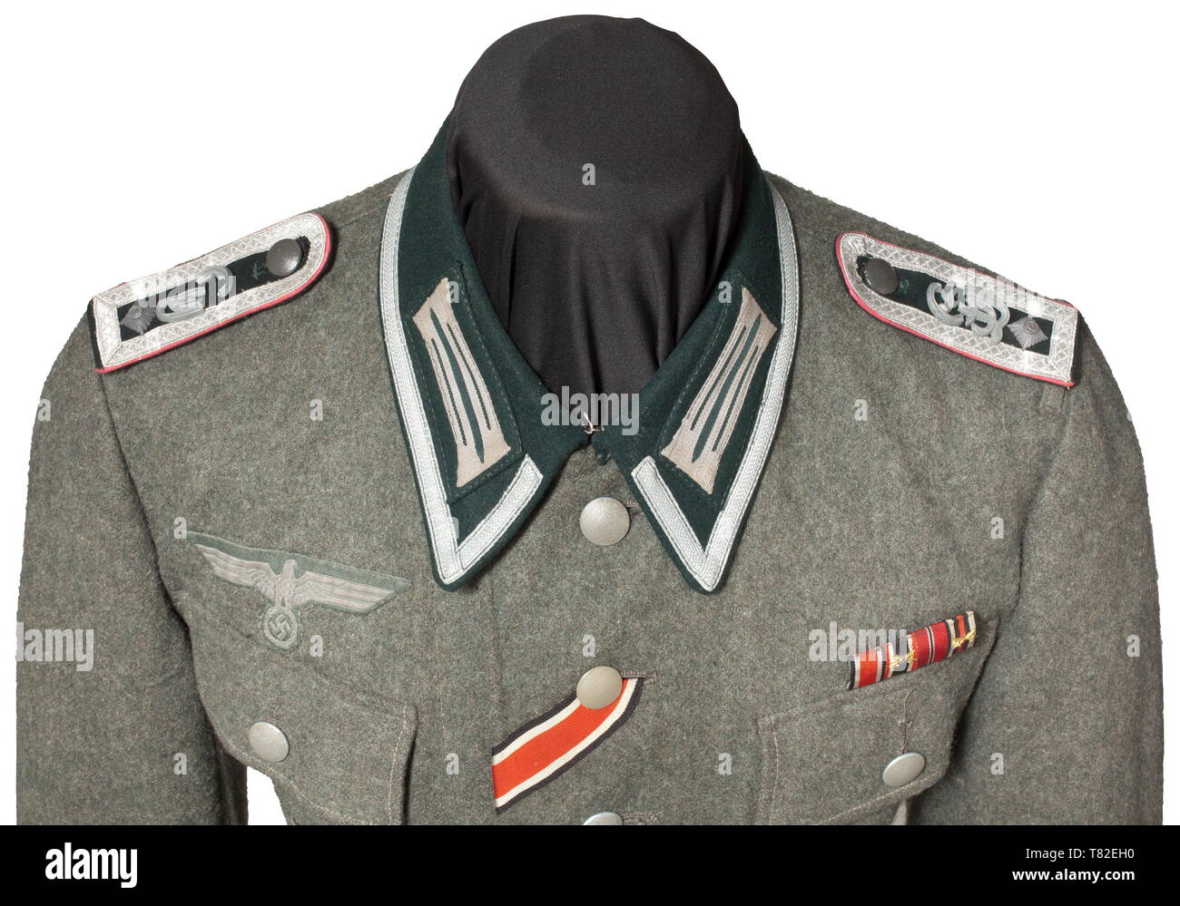 A field tunic M 43 for a Feldwebel in Panzer Regiment 'Großdeutschland' Made of field-grey woollen cloth, dark green turn-down collar with stitched-on collar patches and NCO lace, machine-embroidered national eagle, the petrol blue silk inner liner with size- and depot stampings '161 - 165,39 100 59' and 'T43'. Looped shoulder boards with pink piping, applied rank stars and 'GD' cipher in fine zinc (broken). Affixed to the uniform is the original sewn-on sleeveband 'Großdeutschland', an Iron Cross 1st Class of 1939 (early issue), a field orders c, Additional-Rights-Clearance-Info-Not-Available Stock Photo