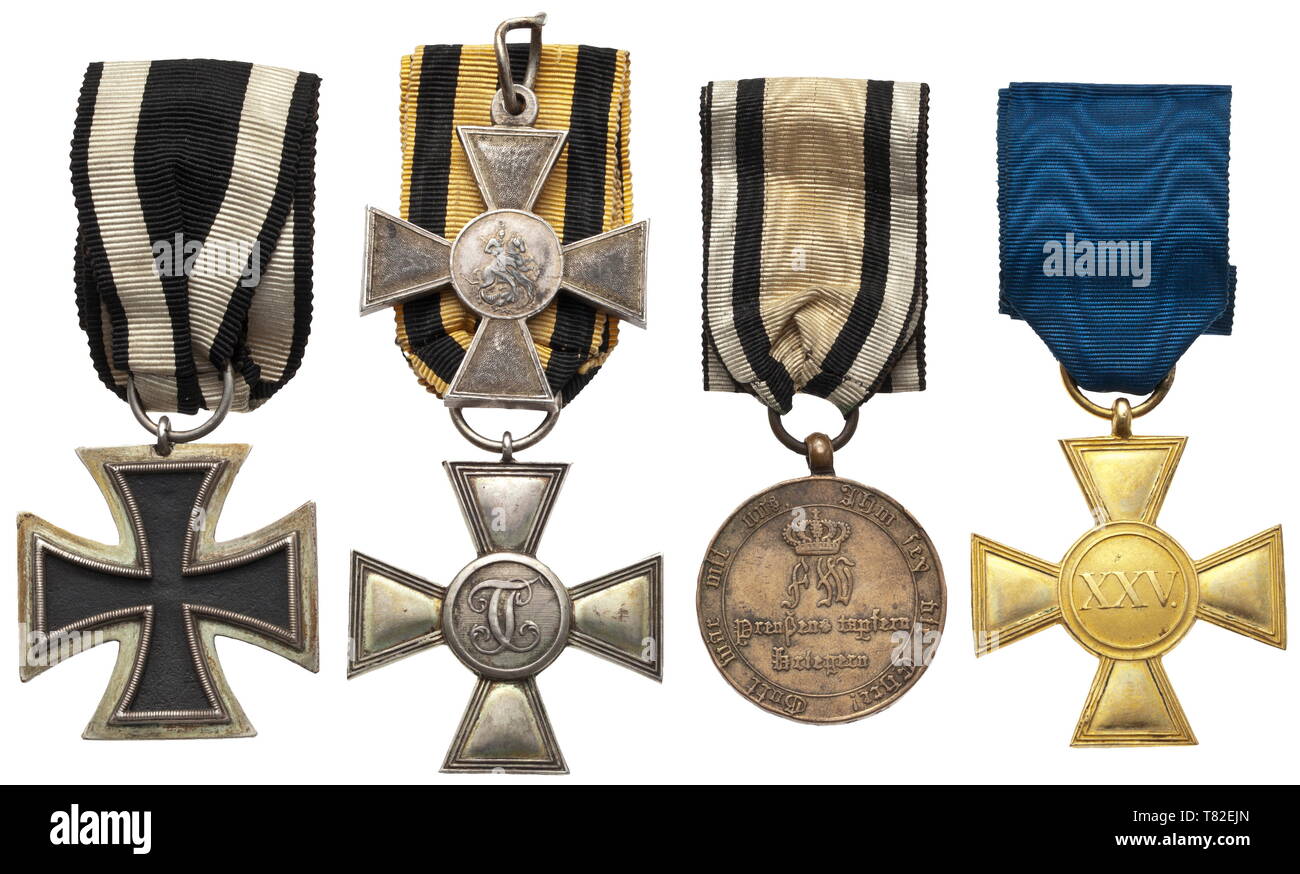 An orders group of a veteran of the Wars of Liberation and later Prussian officer An Iron Cross 2nd Class in reduced 35 mm size, the so-called 'Prinzengröße', a St. George's Cross for Soldiers of Prussian make with separately struck and applied medallions, a Prussian War Commemorative Medal for '1813 - 1814' in the second issue with straight cross arm terminals and a Prussian 25-Year Long Service Award Cros 20th century, Additional-Rights-Clearance-Info-Not-Available Stock Photo